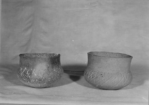 2 Fine gray wide mouthed jars with incised crosshatch decoration all over body