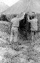 Men adjusting tent