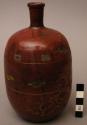 Small necked deep red ceramic bottle