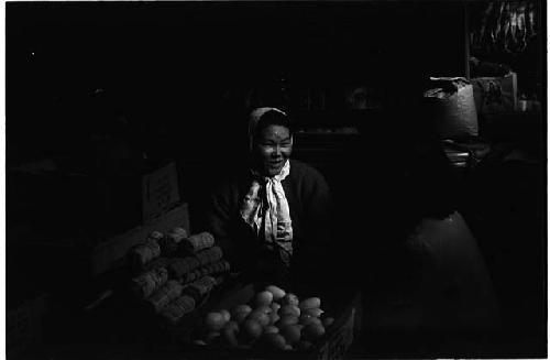 Woman sitting in front of food baskets