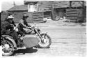 three men riding a three seater motorcycle