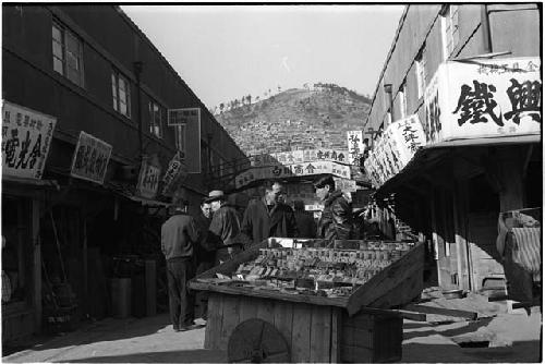 Street with shop signs and vendors