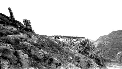 Statues on cliff overlooking river