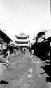 Town scene with pagoda, horses and people