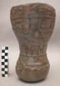 Wooden vessel carved in high relief showing war scenes; human, condor +