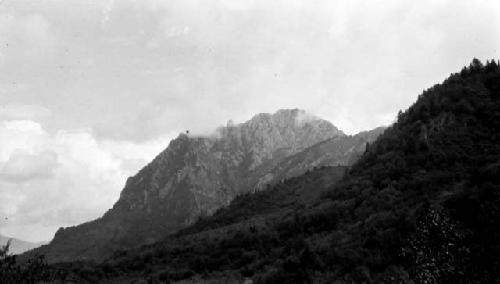 Mountain top, trees and clouds