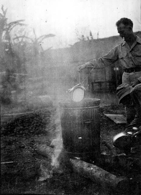 Man with pan and large can