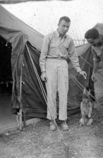 Men feeding dog