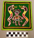 Small yarn painting of figure flanked by snakes
