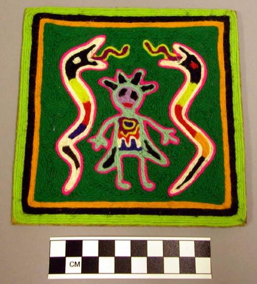 Small yarn painting of figure flanked by snakes