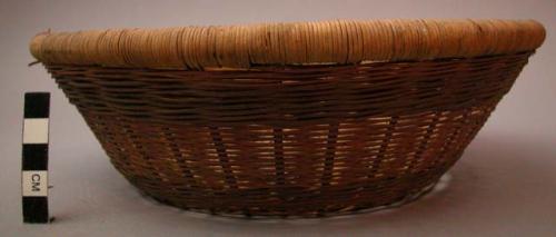 Basket, woven plant fiber, convex base, slightly flared sides, wrapped rim