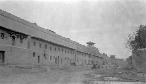 Cart on road by row of buildings