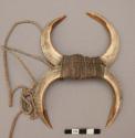 Breast ornament composed of 4 boar tusks held together by cord