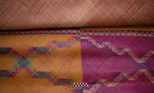 Mat - palm leaf fiber; surface in colored squares with multicolor design