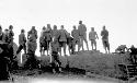 Group of people standing on rocks looking at something