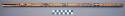End blown bamboo flute with four finger holes; designs carved into surface of th