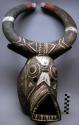 Animal mask with triangular snout and circular horns; wood w/ polychrome
