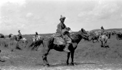 People riding ponies in the desert