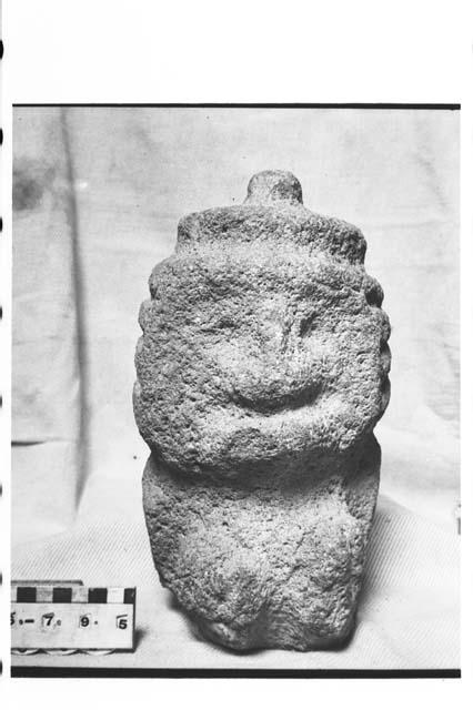 Rough dark grey igneous stone carved into a human head effigy