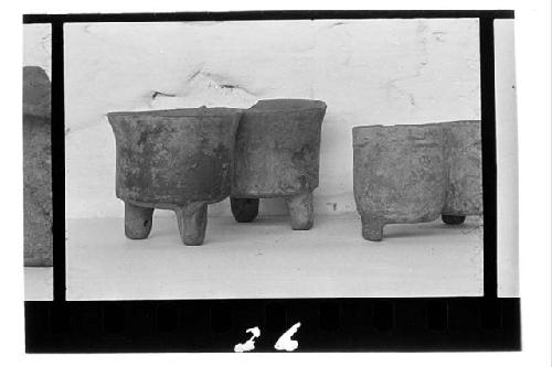 a. Redware double jar. Four cylindrical legs. Hole running between each near bas