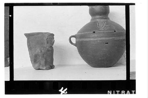 a. Red brown effigy jar  Height 4 3/4  b. Reverse of 3a showing "killing" in thr