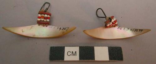 Pair of Men's mother-of-pearl ear ornaments (tatanyon); lunate-shape +