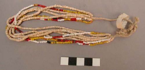 Child's necklace (xaulus) of shell and glass beads, worn by it during +