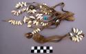 Ornament, leather fringe with cowrie shells, brass bells and blue beads