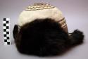 Round white felt hat with earflaps and front and back flaps of dark +