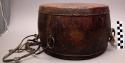 Large double-faced wooden drum with carrying strap attached to +