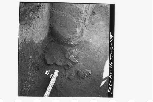 Potsherds at corner of Structure 1B, lying in 1C on floor.  In section N59.3E.