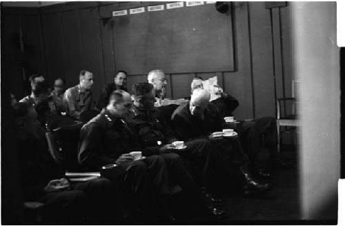 Men sitting down in conversation