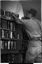 Man choosing a book from a shelf