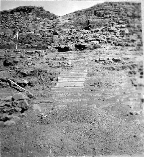 Step fragments. and walls of central Str. sanctuary. Looking E.