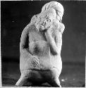 Fgurine, seated woman with head to one side, palm on cheek. 0.17, 16-Bis