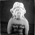 Figurine, seated human, elaborate headdress, 2 perforations. 0.35, 5-Bis