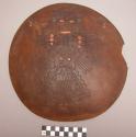 Wooden dish, human figures incised in convex side, inlaid with shell, turquoise, and glass beads.  Interior decorated with incised fish.