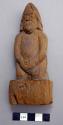 Carved wooden figure - human on pedestal