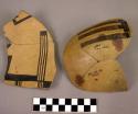 Fragment of black on yellow pottery bowl--restored