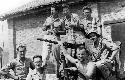 Soldier posing with large gun and ammunition