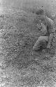 Man kneeling by grave