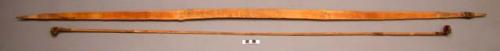 Light colored hard wood bow with bamboo bowstring and raffia (61")
