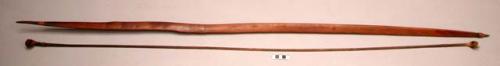Dark hard wood bow with bow string of bamboo wrapped with raffia +