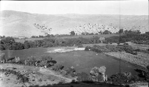 View to the East; Ruin in Center; Shrines on Hill in Left Background