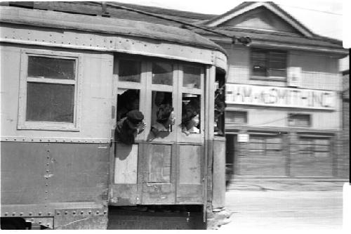 train passing with people sticking their heads out