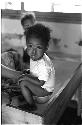 Small child sitting on a potty at an orphanage