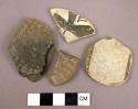 Worked pottery sherds, 2 corrigated, 2 black & white designed