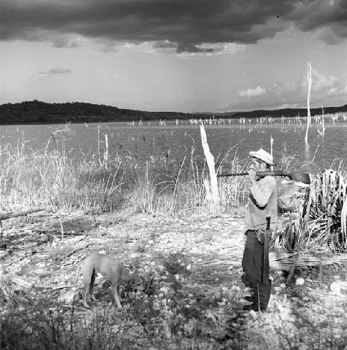 Man and dog in view of Yaxha from Topoxte