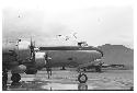 Airplane on tarmac with mountain visible in background