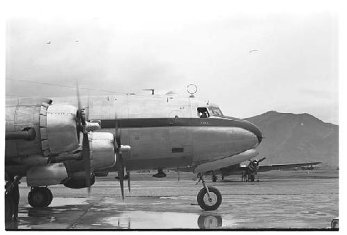 Airplane on tarmac with mountain visible in background